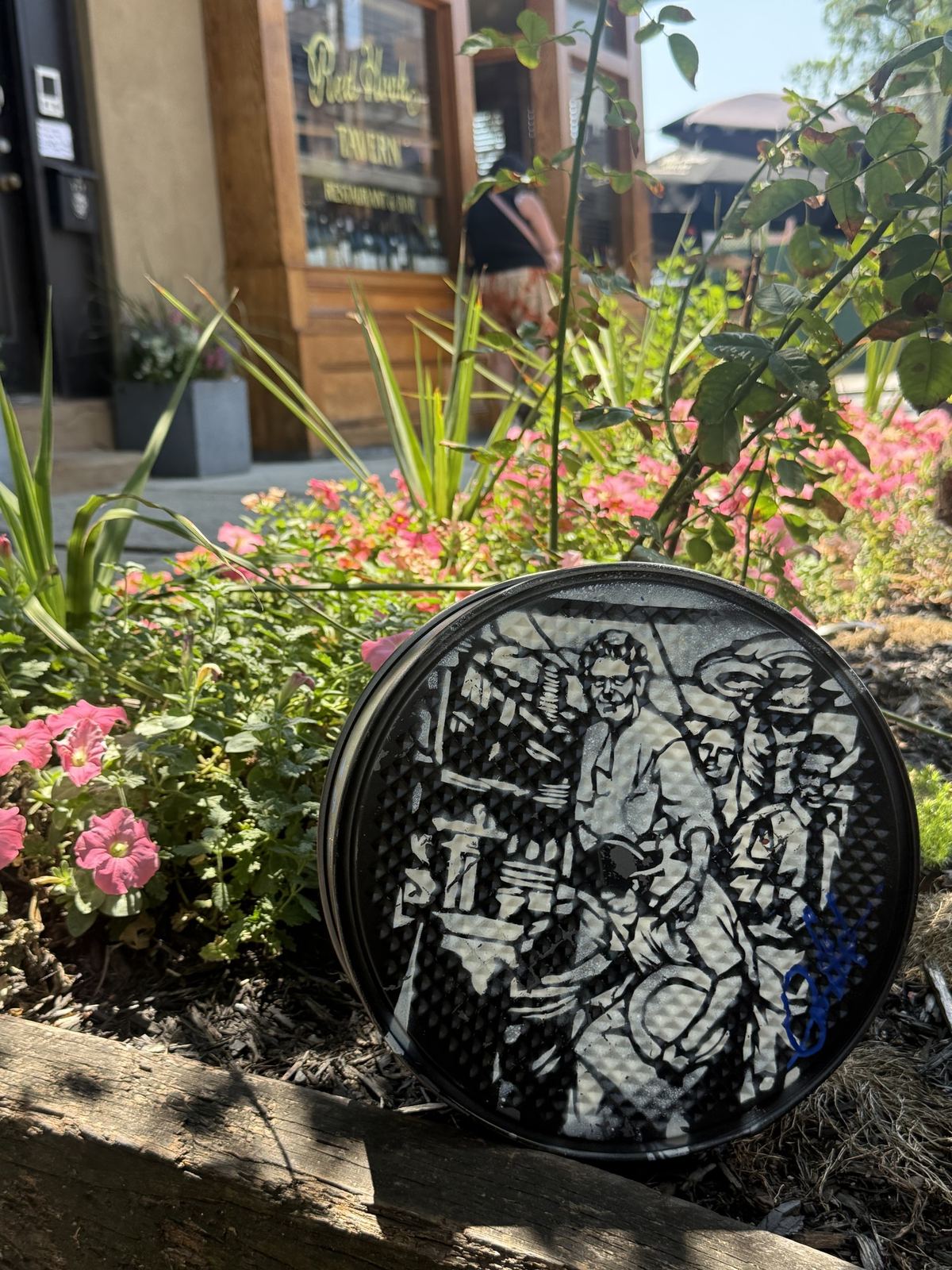 A GEM Movement record piece hidden among flowers, waiting to be found