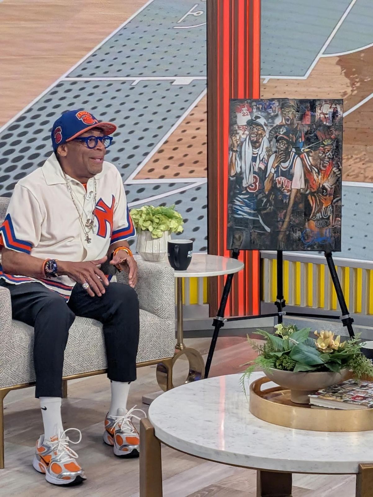 Spike Lee seated beside the canvas Andres Gallardo painted for him