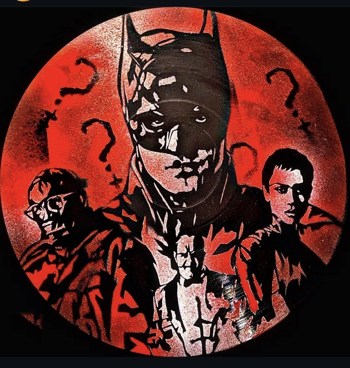 Batman stenciled on a vinyl record in red and black by Andres Gallardo