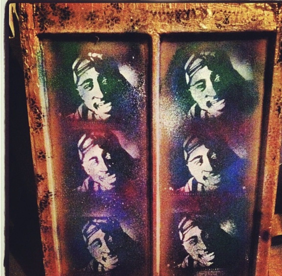 Six stencil portraits of Tupac sprayed on a rusted door by Andres Gallardo