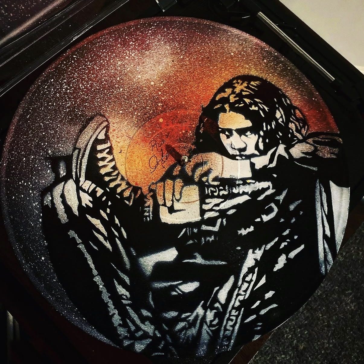 Stencil portrait on a vinyl record by Andres Gallardo