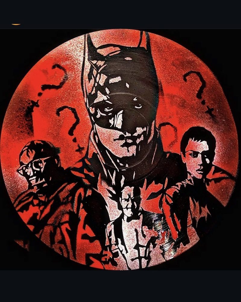 Batman stenciled on a vinyl record in red and black by Andres Gallardo