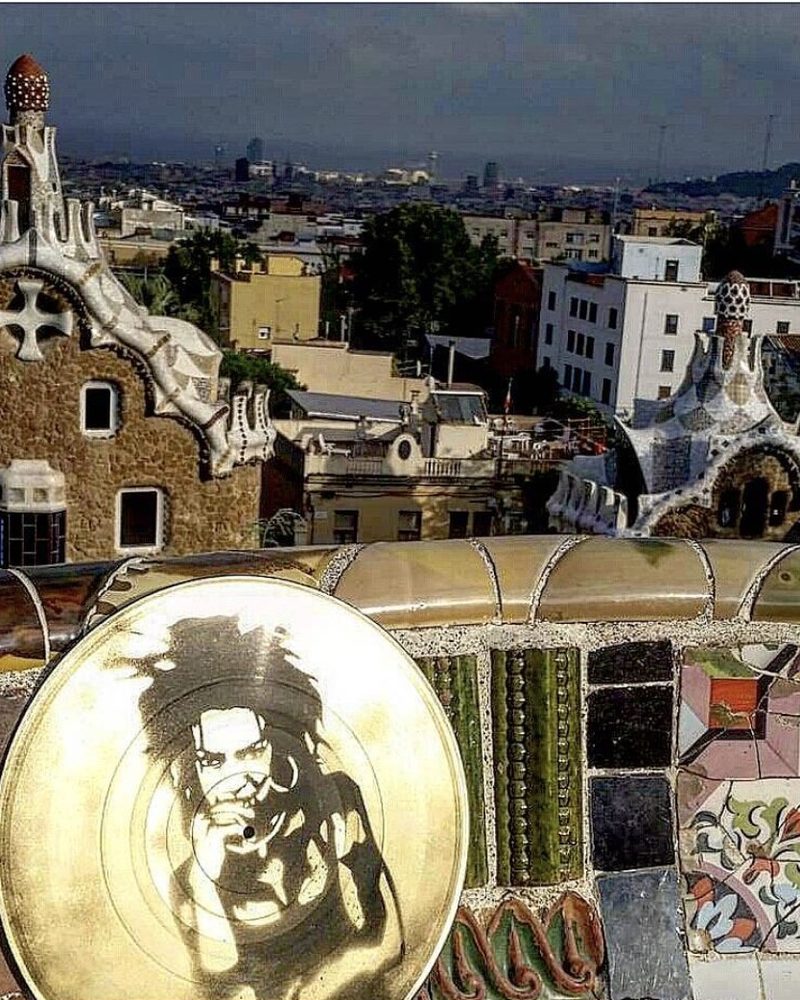 A GEM Movement record piece resting on the mosaic wall of Park Güell, Barcelona