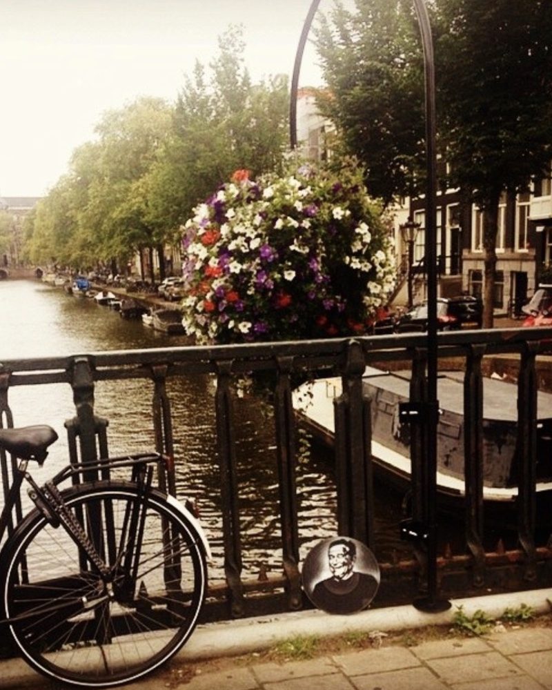 A GEM Movement record piece beneath a bicycle on a canal bridge, Amsterdam