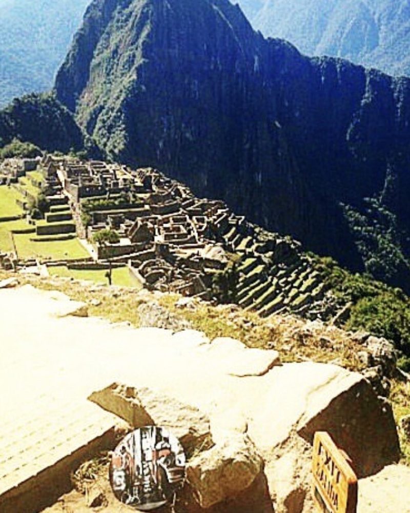 A GEM Movement record piece on a stone ledge above the terraces of Machu Picchu, Peru