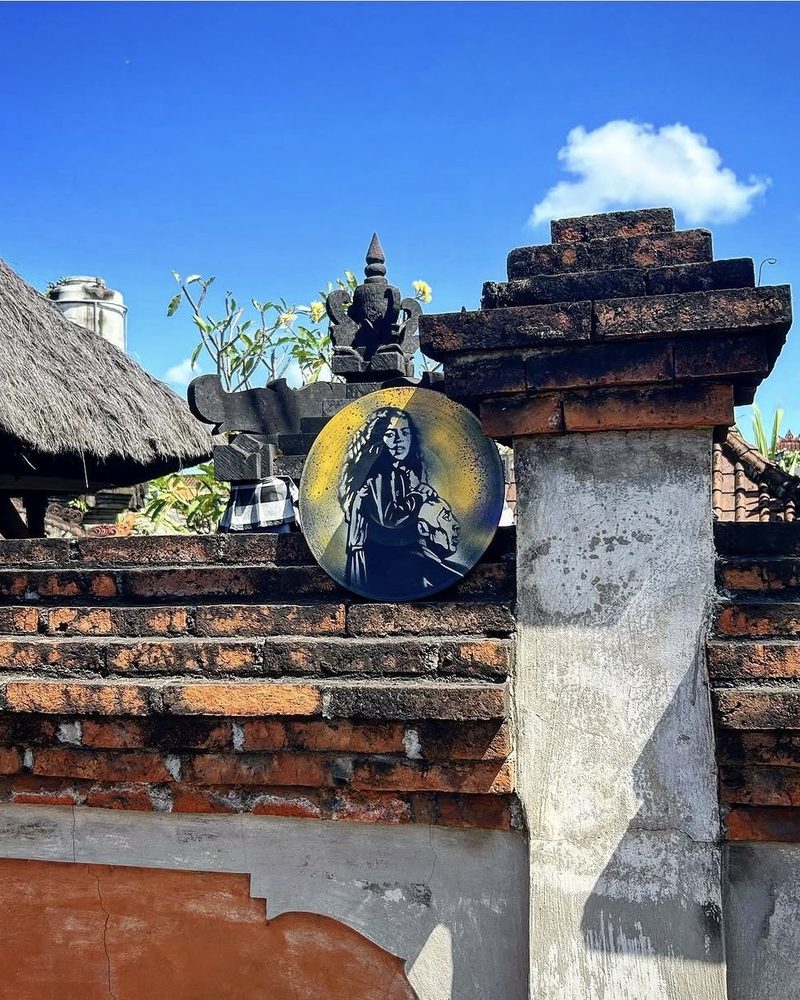 A GEM Movement record piece set on a brick temple wall under a blue sky, Bali